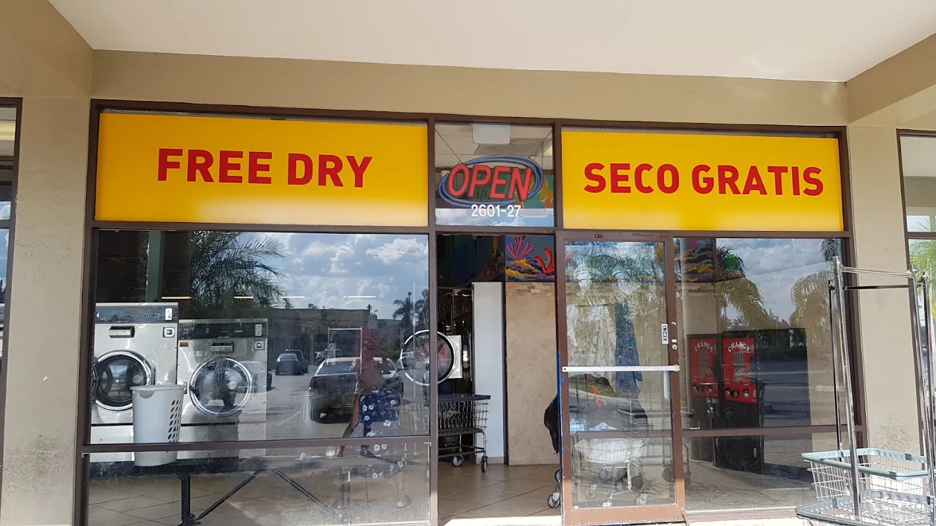 Washers, folding tables, and seating inside Cresthaven Coin Laundry